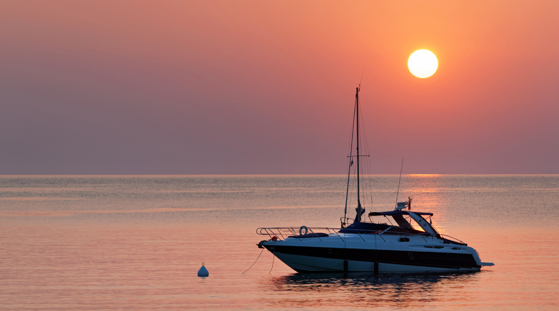 Private boat sailing at sunset on the Ionian Sea